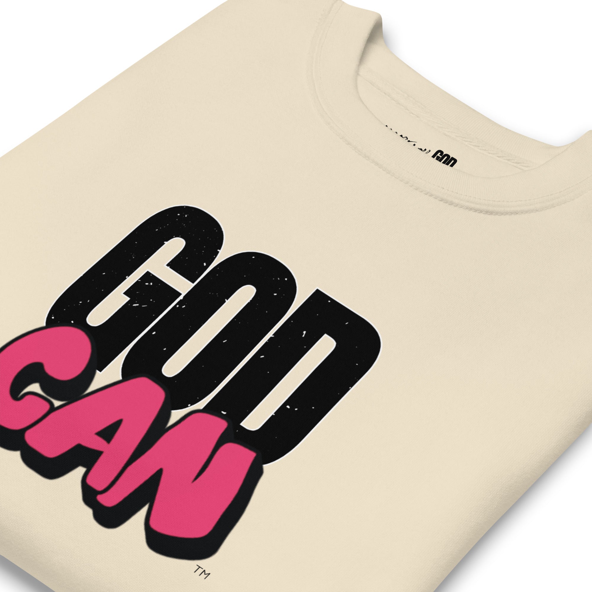 Beige t-shirt with 'GOD CAN' text in black and pink on a white background